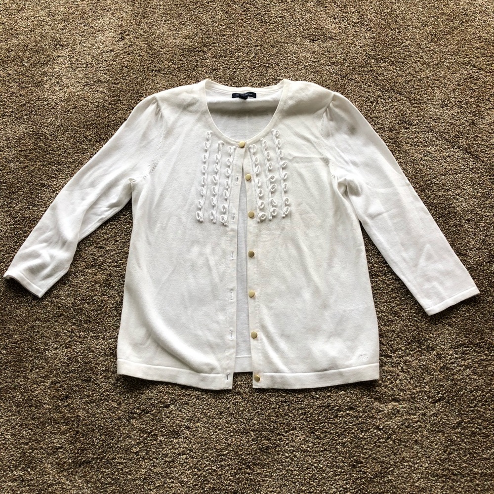 White Tommy Hilfiger sweater with gold buttons.